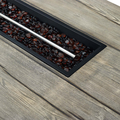 Rectangular light gray outdoor patio fire pit table on a weathered wooden deck.