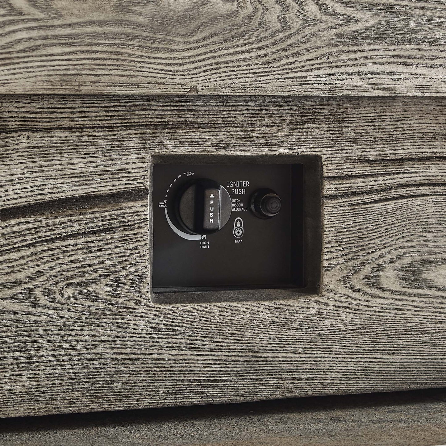 Rectangular outdoor fire pit table in light gray with a black control panel featuring ignition dial and push button.