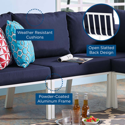 Navy outdoor armless chair with weather-resistant cushions, white powder-coated aluminum frame and slatted back.