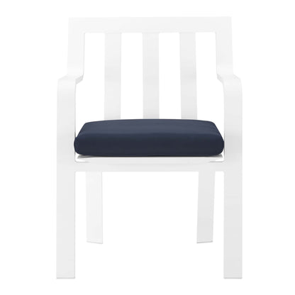 White modern outdoor patio aluminum dining armchair with navy cushion, slatted back and straight-frame legs.