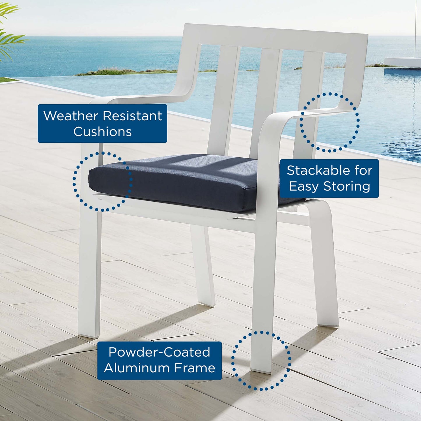 White powder-coated aluminum outdoor patio dining armchair with a navy cushion; stackable for easy storage beside a pool.