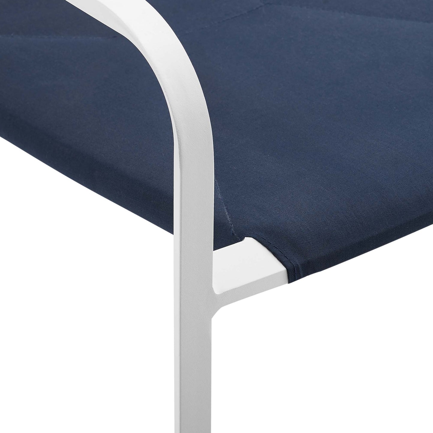 White aluminum-framed outdoor chair with navy blue fabric sling seat and curved armrests.