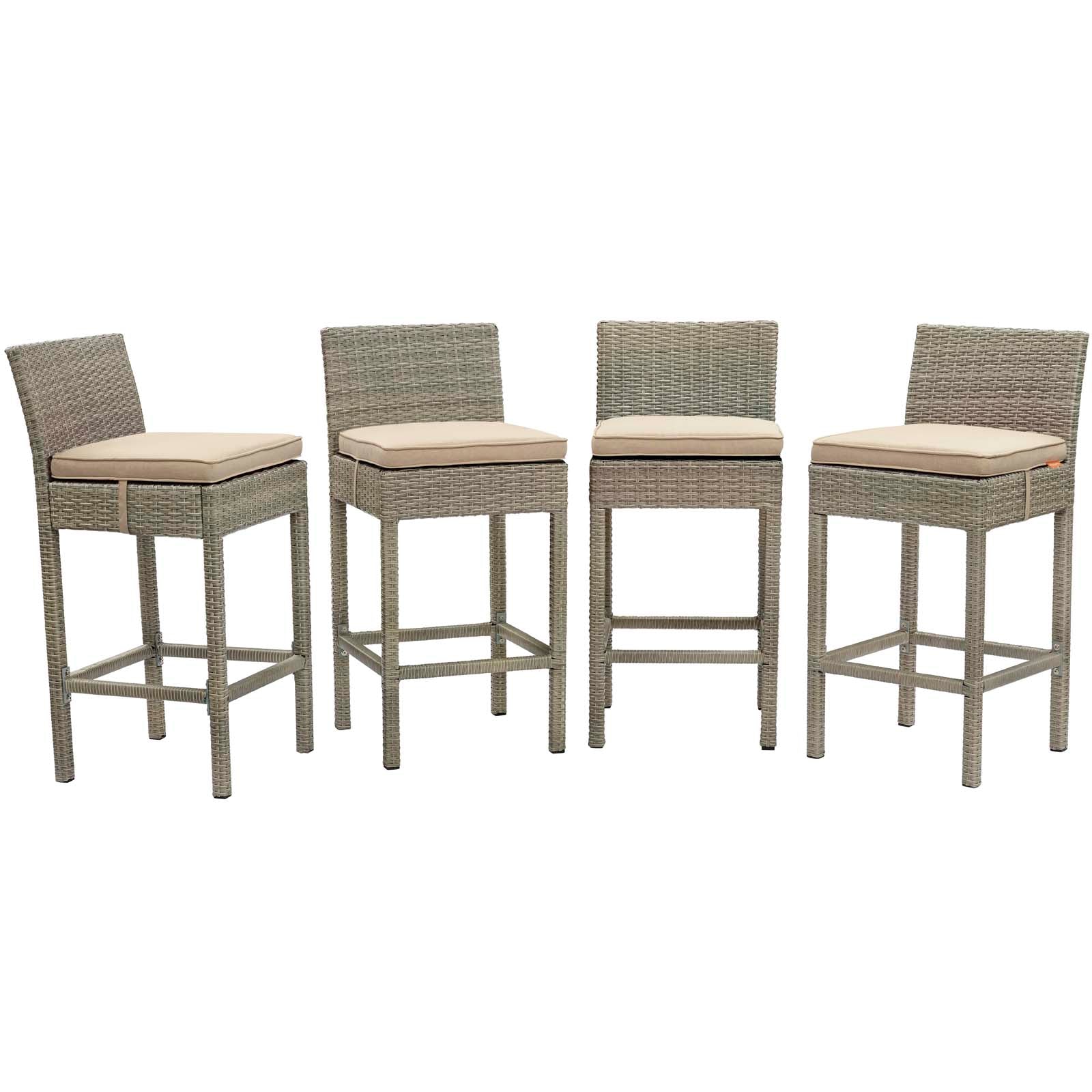 Four gray wicker bar stools with beige cushions, square legs and footrests.