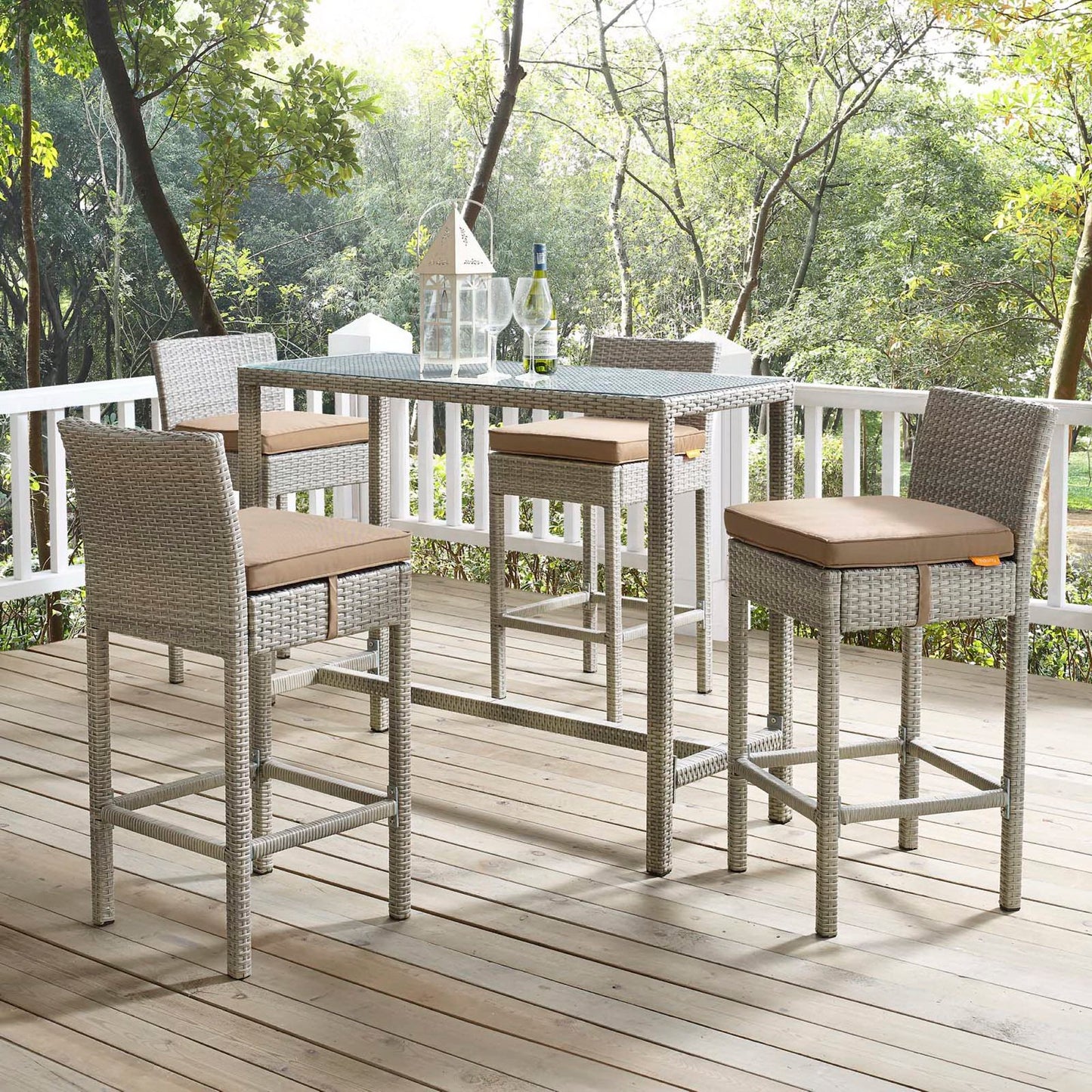 Grey wicker outdoor bar-height stools (set of 4) with tan cushions on a wooden deck.