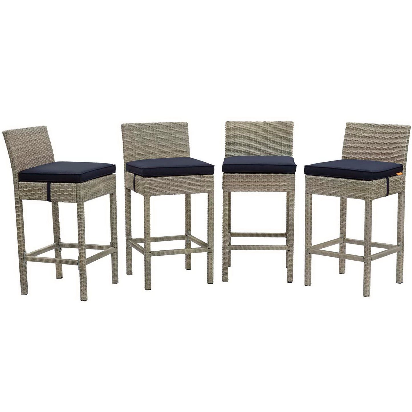Set of four gray wicker bar stools with navy cushions, straight backrests and built-in footrests.