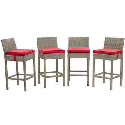 Set of four gray wicker bar stools with red cushion seats, tall backs and footrests for outdoor patio.