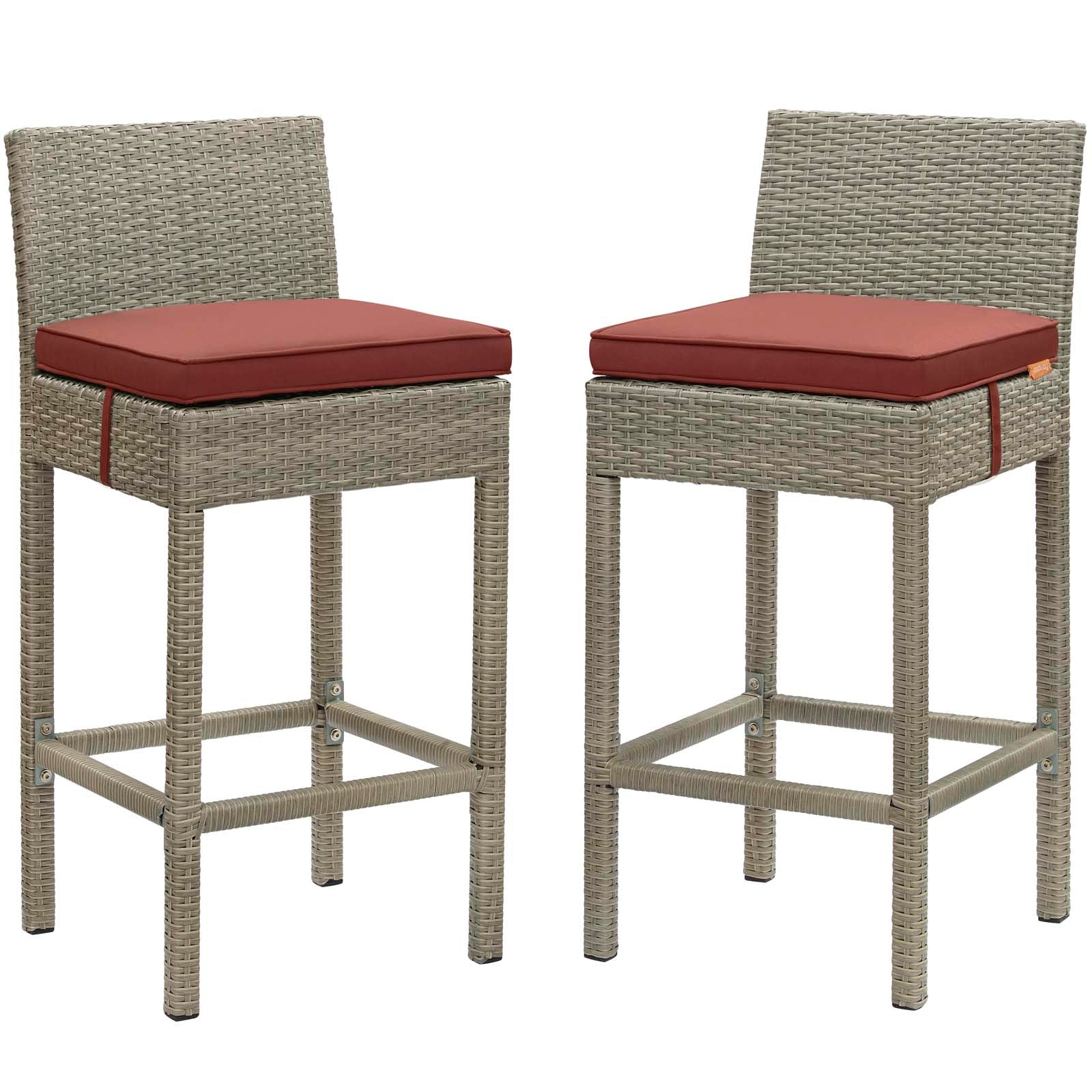 Pair of tall gray wicker bar stools with red cushions and footrests for outdoor patio use.