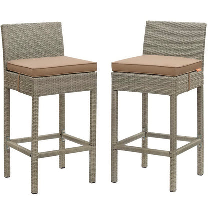 Pair of gray wicker bar stools with mocha cushions, high backs, and footrests.