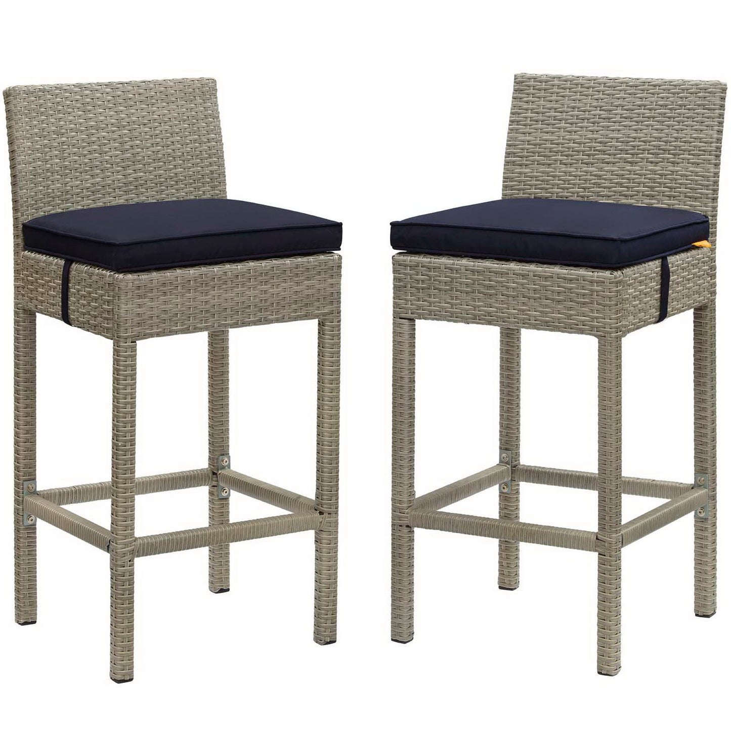 Pair of light gray wicker outdoor bar stools with navy cushions, square woven frames & footrests.