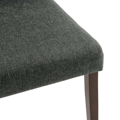 Grey textured fabric upholstered dining side chair with a dark wood tapered leg and curved edge.