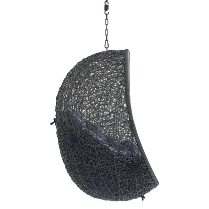 Grey woven crescent hanging chair with navy cushion and chain suspension.
