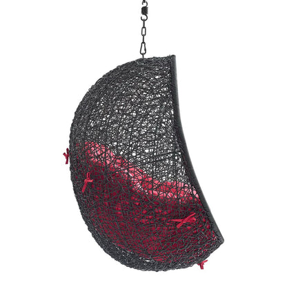 Open-weave black hanging half-sphere chair with red cushion interior and chain hanger.