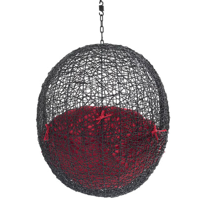 Black woven spherical hanging chair with red cushion and chain hanger.