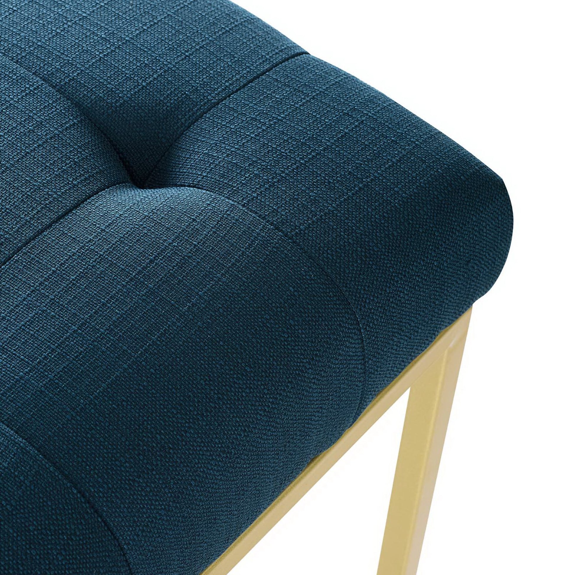 Blue tufted fabric dining chair with square pattern and gold stainless steel legs, modern accent seating.