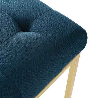 Blue tufted fabric dining chair with square pattern and gold stainless steel legs, modern accent seating.