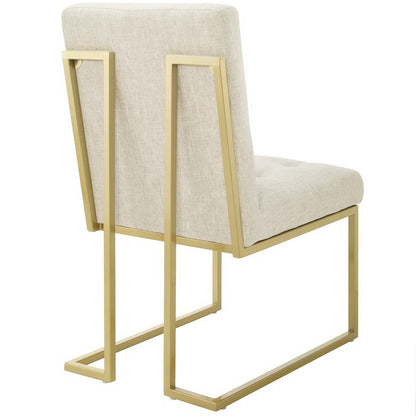 Beige upholstered dining accent chair with a gold metal square-frame cantilever base.