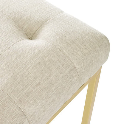 Beige fabric upholstered dining accent chair with tufted cushion and gold-tone stainless steel legs.
