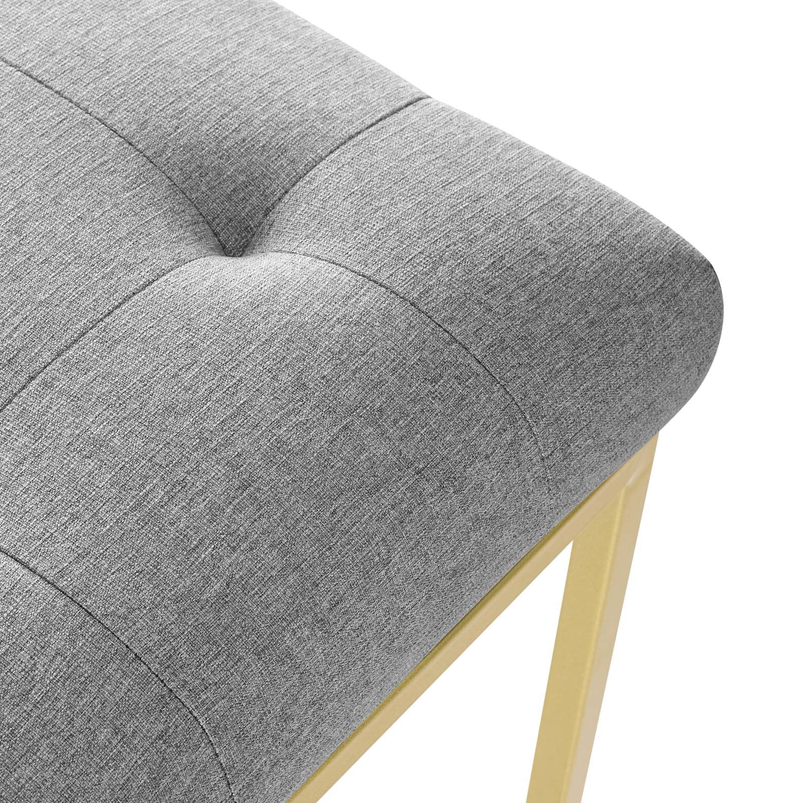 Gray tufted fabric dining chair with square-seamed cushion and gold stainless-steel legs