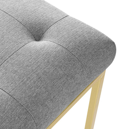 Gray tufted fabric dining chair with square-seamed cushion and gold stainless-steel legs