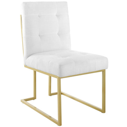 White tufted accent chair with a gold-finish metal cantilever frame and cushioned back