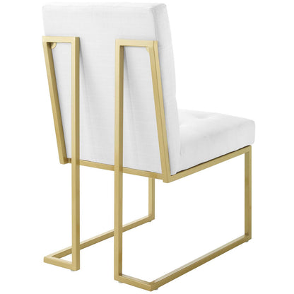 Gold-tone metal frame cantilever chair with white upholstered seat and back cushions, modern geometric style.