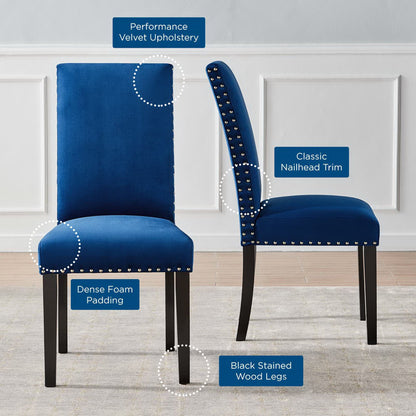 Set of two navy blue performance velvet dining chairs with nailhead trim, dense foam padding and black stained wood legs.