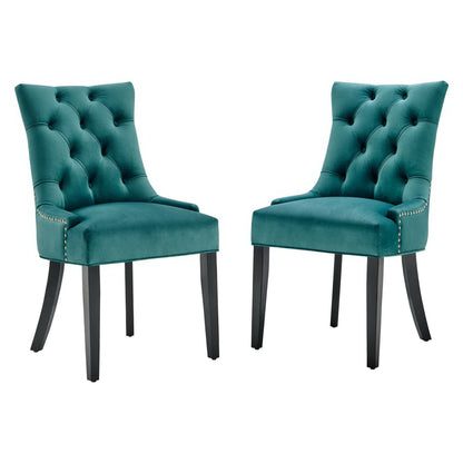 Pair of blue velvet tufted dining chairs with nailhead trim and dark curved legs