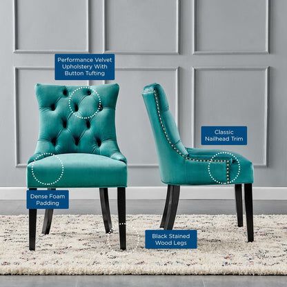 Pair of blue velvet dining side chairs with button tufting, nailhead trim, dense foam padding and black stained wood legs.
