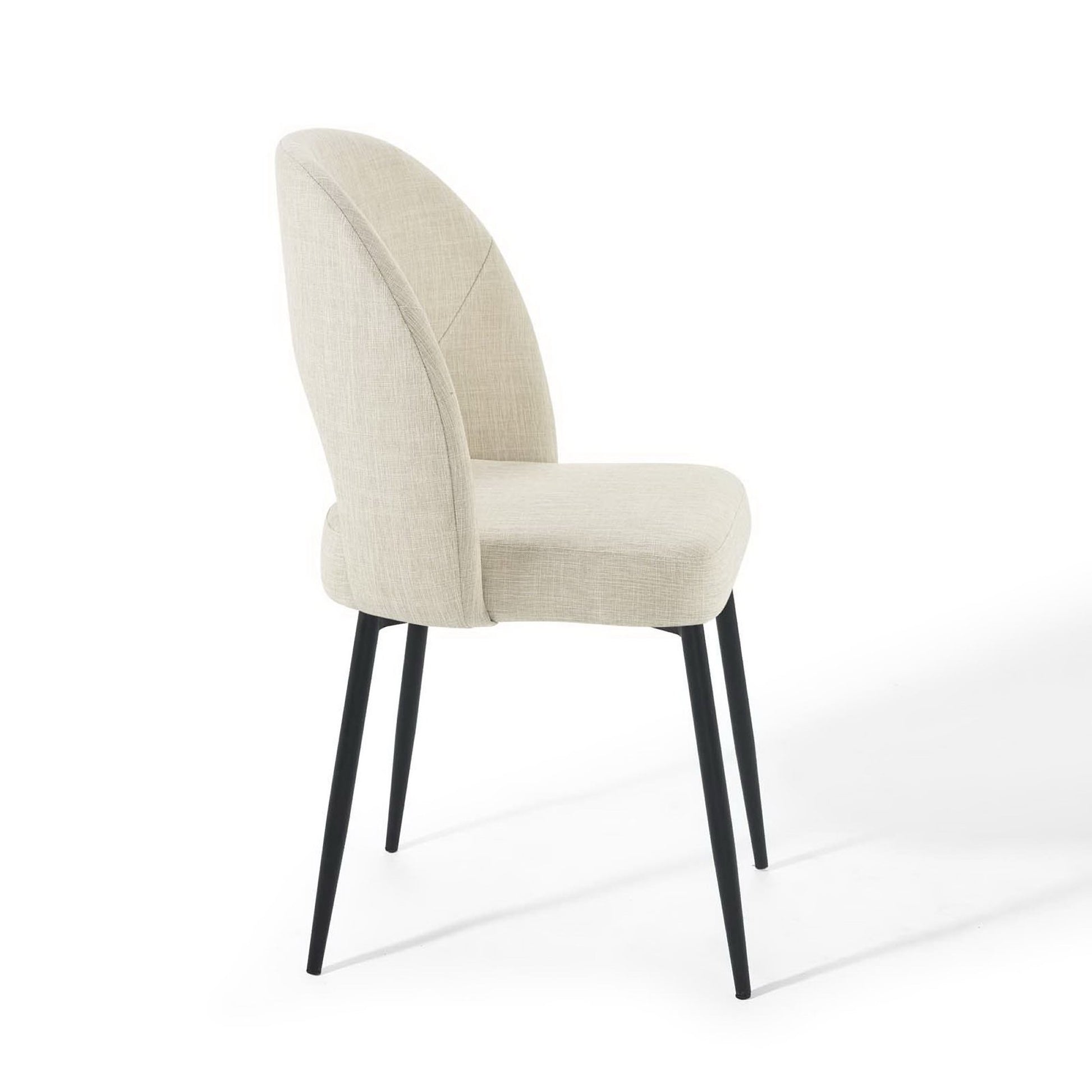 Beige upholstered dining chair with curved back and slim black legs.