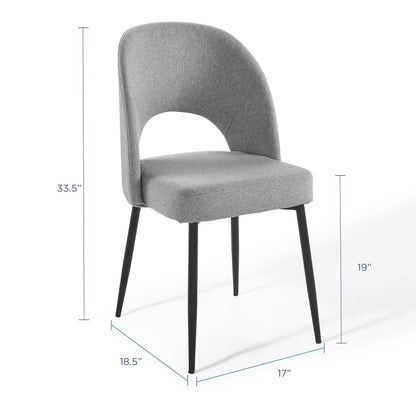 Gray upholstered dining side chair with curved back and open cutout, black tapered legs.