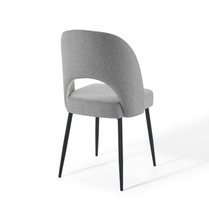 Light gray fabric upholstered dining chair with curved back & arm wrap, black tapered metal legs.