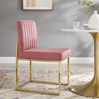 Pink velvet dining chair with a gold metal sled base, vertical channel-tufted back, contemporary glam style.