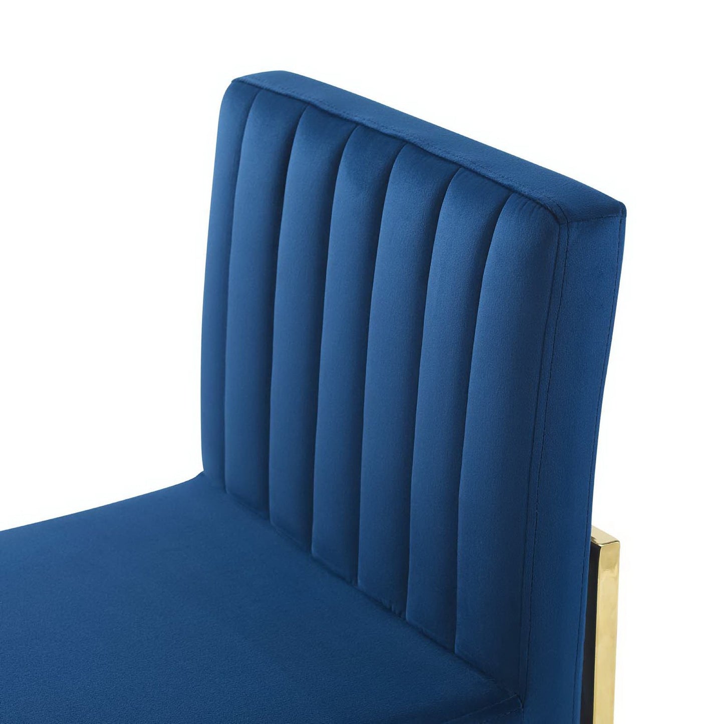 Navy blue velvet dining chair with vertical channel tufting, high back, and gold metal frame.