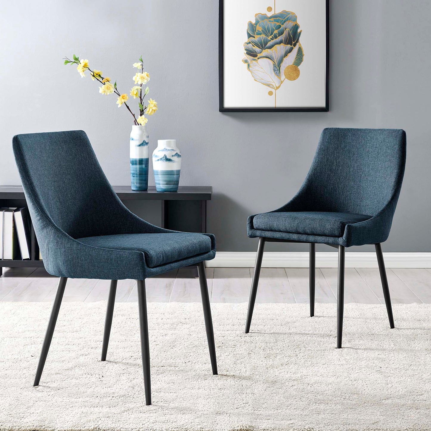 Pair of blue upholstered dining chairs with black metal legs