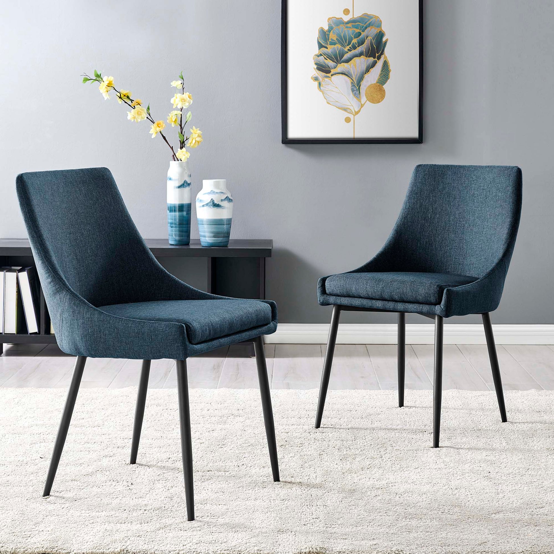 Pair of blue upholstered dining chairs with black metal legs