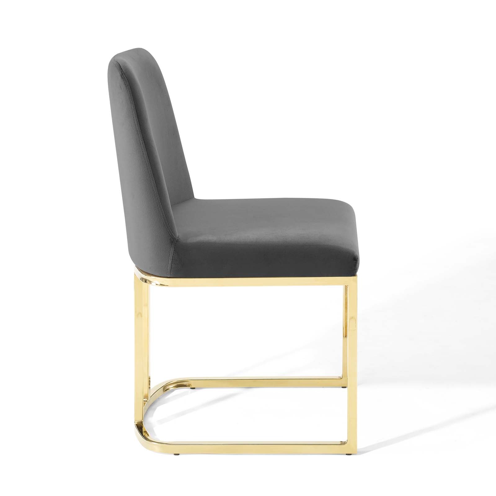 Grey velvet upholstered dining chair with a gold-tone sled base