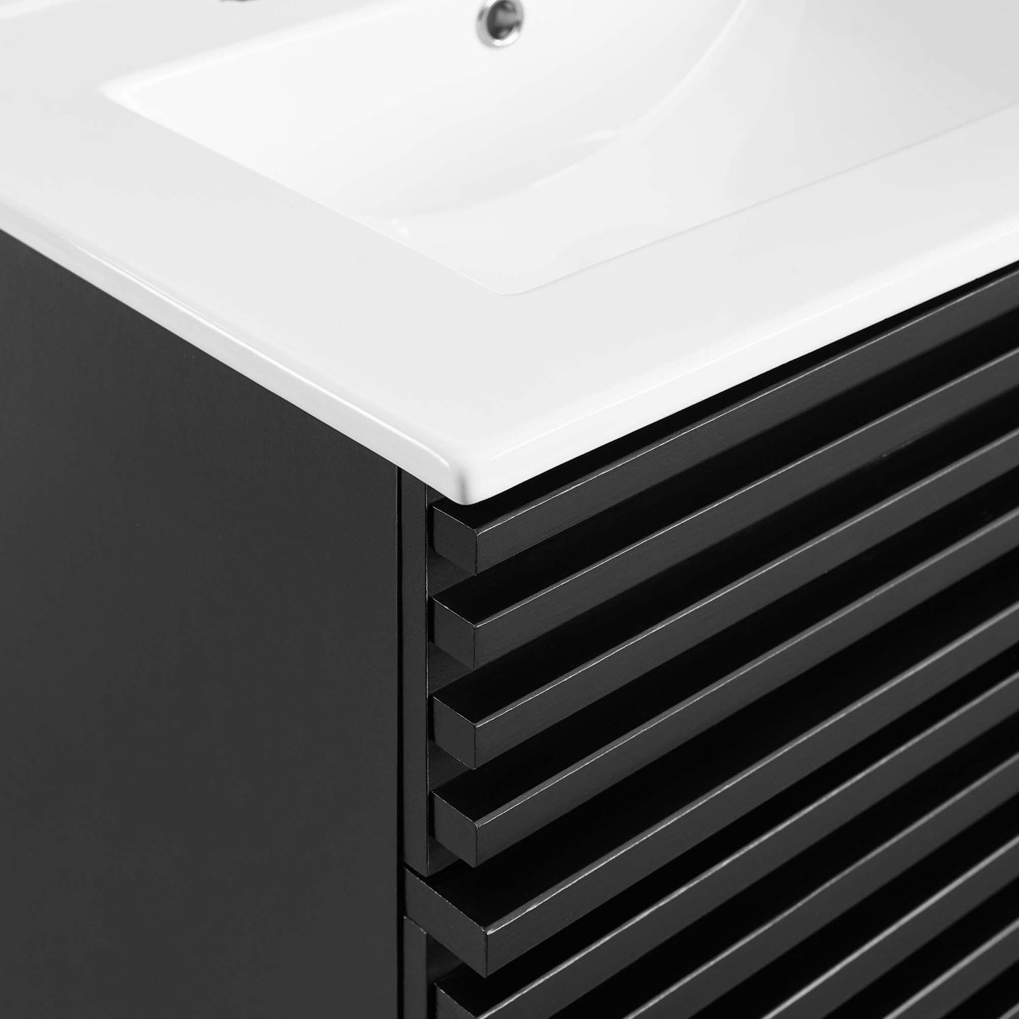 Black modern bathroom vanity with white countertop and integrated sink; horizontal slat drawer fronts.
