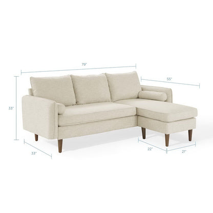 Beige fabric L-shaped sectional with chaise, three back cushions and tapered wooden legs.