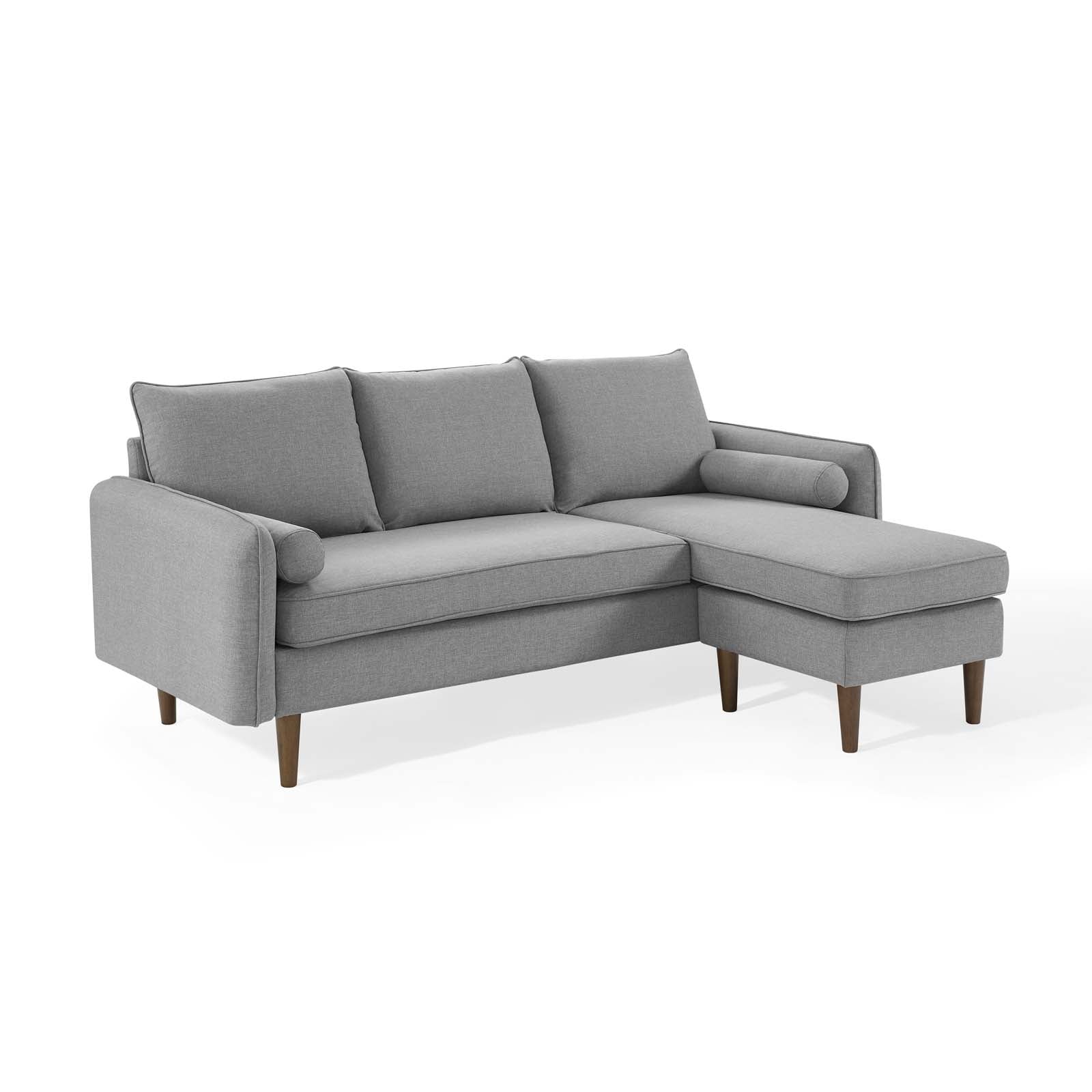 Light gray fabric sectional sofa in an L-shape with a right-side chaise, three back cushions, and wooden legs.