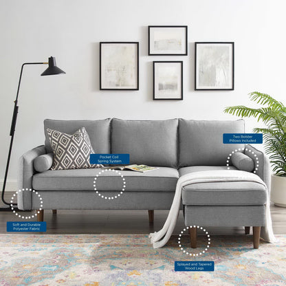 Light gray L-shaped sectional sofa with chaise, wooden tapered legs, and a throw pillow and blanket in a modern living room.