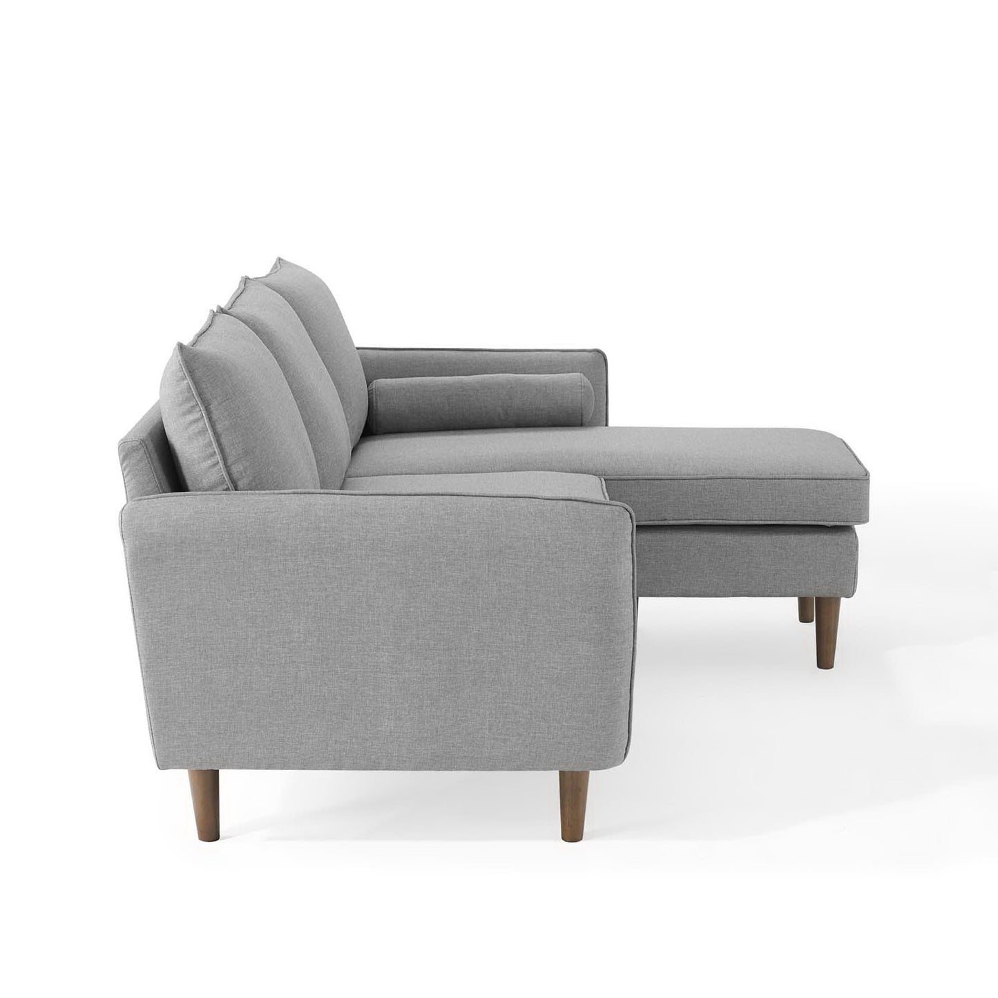 Light gray fabric sectional sofa with chaise, three back cushions, and tapered wooden legs.
