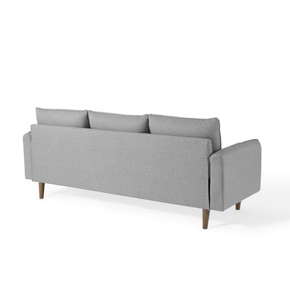 Light gray fabric sectional sofa with wooden tapered legs, three back cushions, square arms, mid-century modern style.