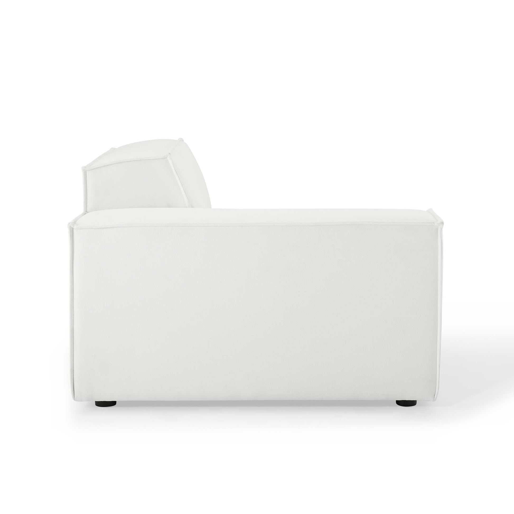 White fabric sofa with chaise extension on left, plush angled back cushion, clean modern lines.