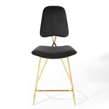 Black velvet upholstered curved-back counter stool with gold metal legs and footrest.