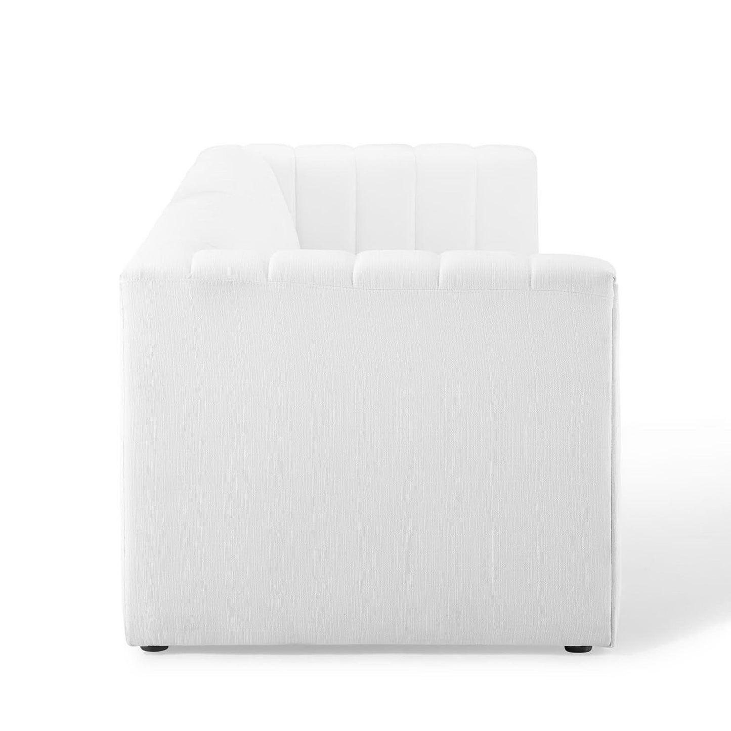 White fabric upholstered sofa with tufted back cushions and low-profile feet.