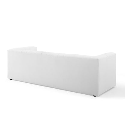 White fabric upholstered channel-tufted sofa with low back.