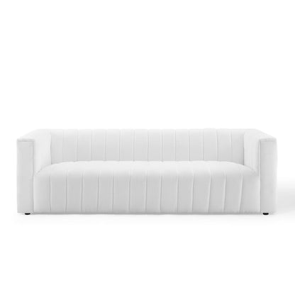 White upholstered sofa with vertical channel stitching, square arms, modern living room style.