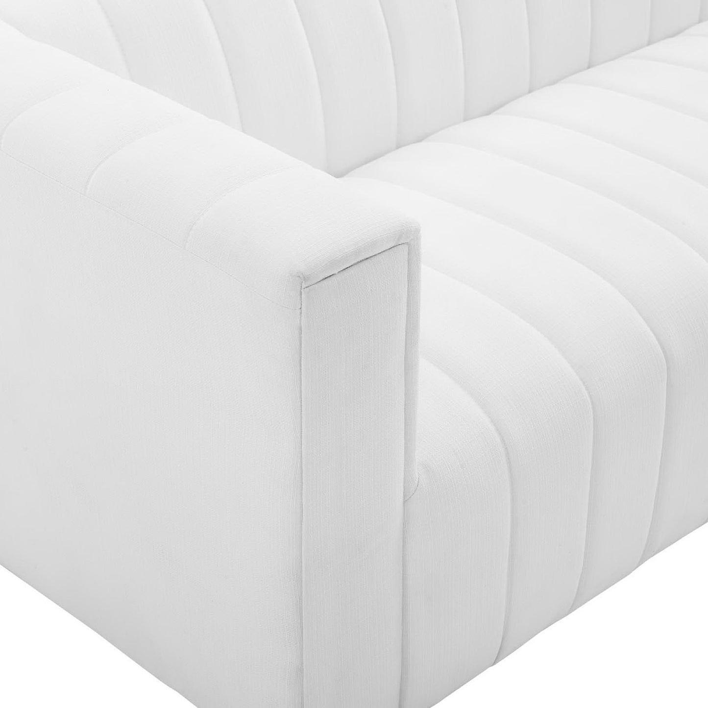 White fabric-upholstered sofa with square armrest and vertical channel-stitch detailing.