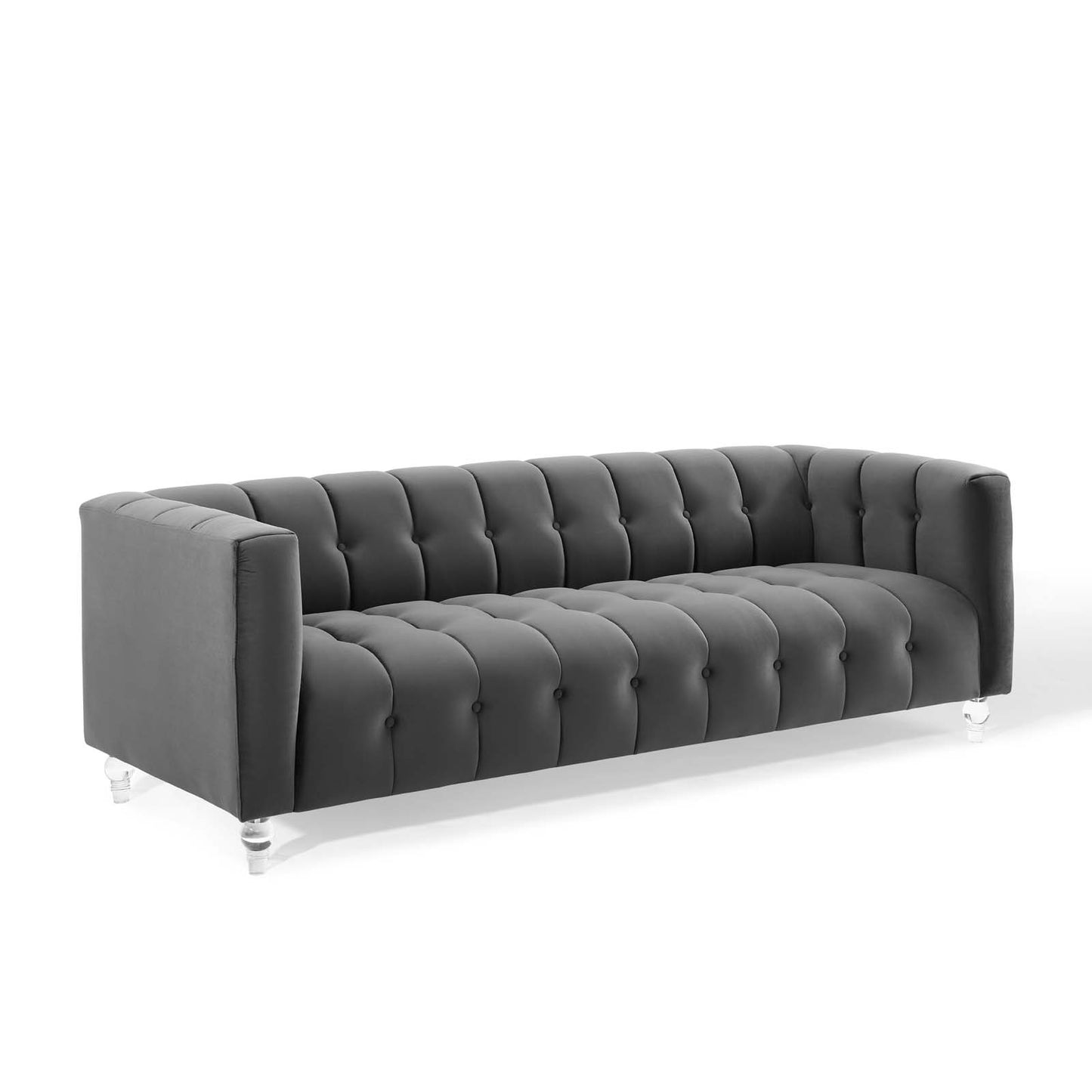Dark gray tufted velvet sofa with square arms, buttoned back and seat, on clear acrylic legs.