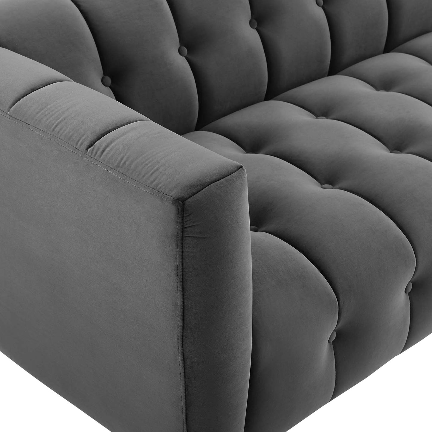 Charcoal velvet channel-tufted sofa with rounded armrests.